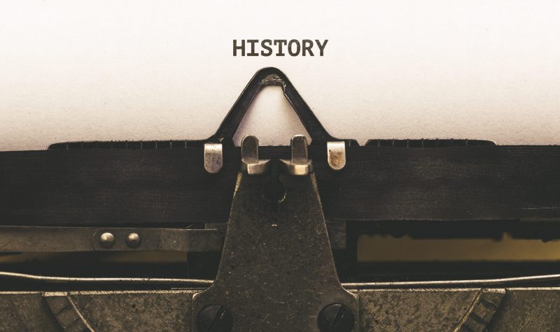 History, Text on paper in Vintage type writer machine from 1920s closeup with paper