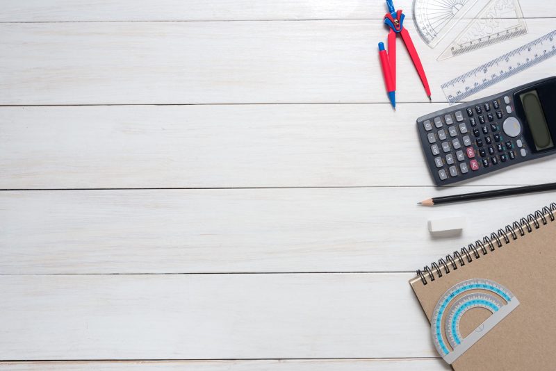 School stationery and office supplies on white table, math conce