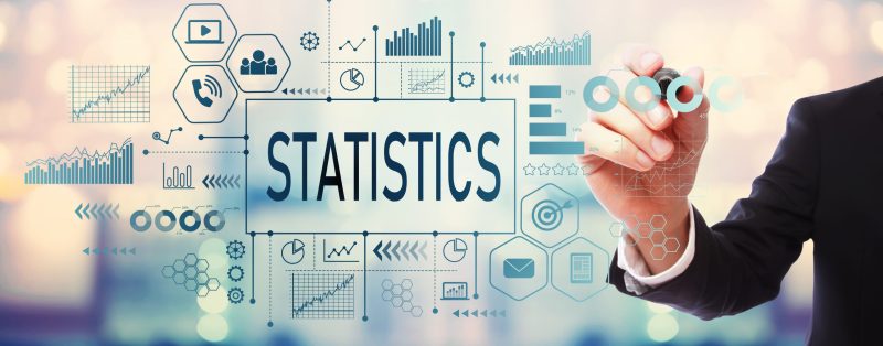 Statistics with businessman on blurred abstract background