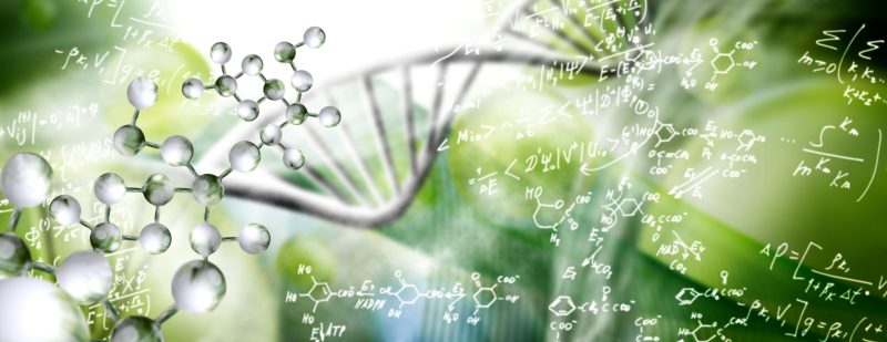 Abstract image of a DNA chain on a blurry background close-up. Chemical and mathematical formulas are randomly located in the background.